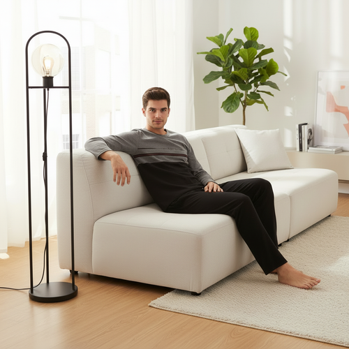 Man in pajamas on sofa without iPad - square