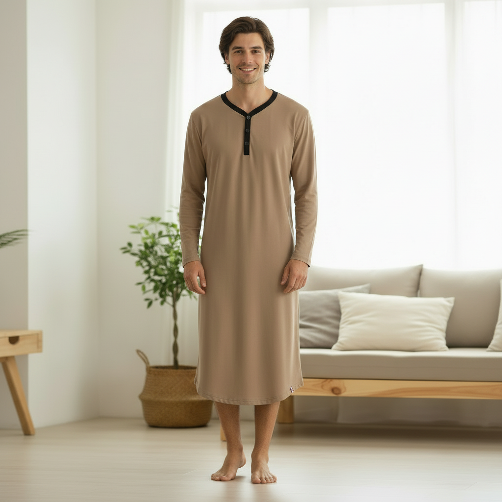 Young man wearing tan lounge dress with hands at sides